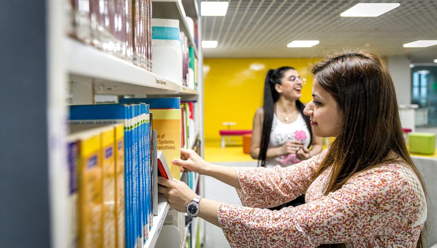 Student browsing books in the KIIT library