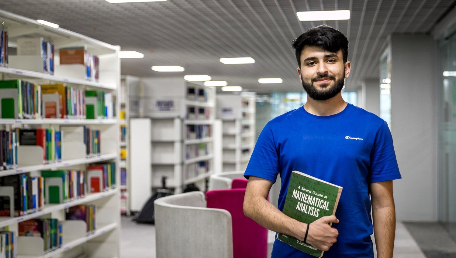 Student with a book in the KIIT library